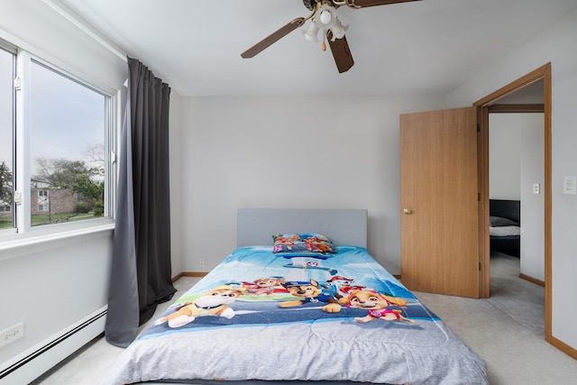 carpeted bedroom featuring baseboard heating and ceiling fan