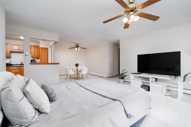 bedroom featuring a baseboard heating unit, light colored carpet, baseboards, and a ceiling fan