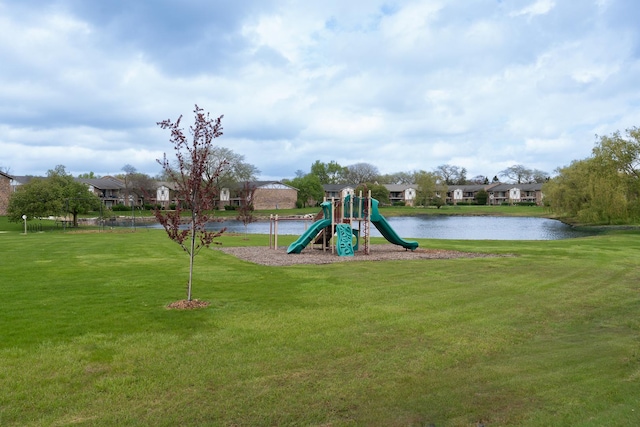 community play area with a water view, a lawn, and a residential view