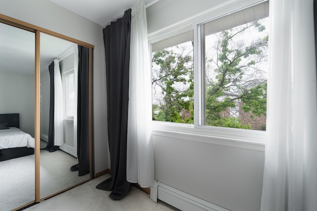 bedroom with light carpet and multiple windows