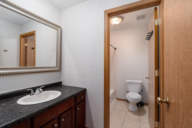 bathroom featuring toilet, tile patterned floors, vanity, and shower / tub combo