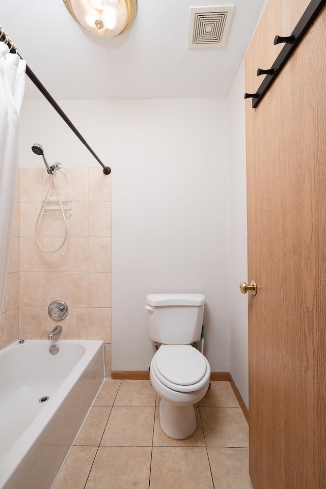 bathroom featuring tile patterned floors, toilet, shower / tub combo, and baseboards