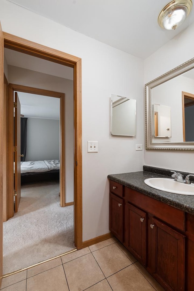 bathroom featuring tile patterned floors, vanity, and baseboards