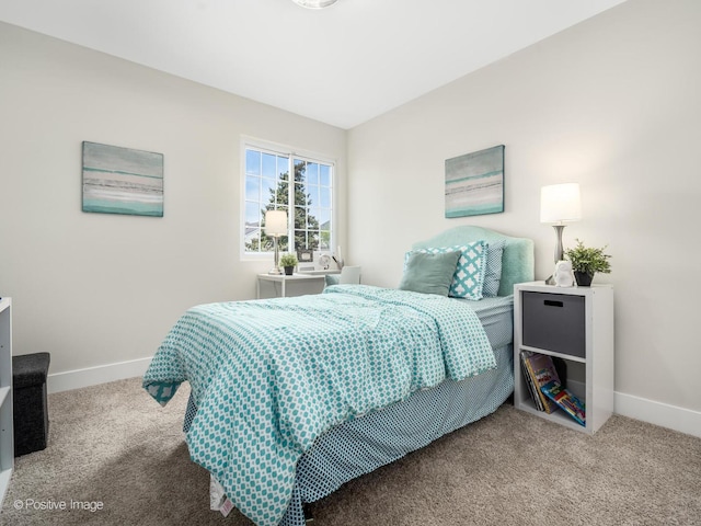 carpeted bedroom featuring baseboards