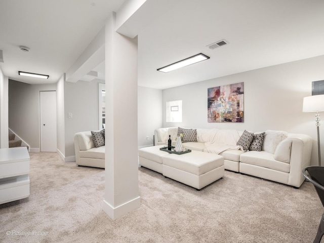 carpeted living area featuring baseboards and stairway
