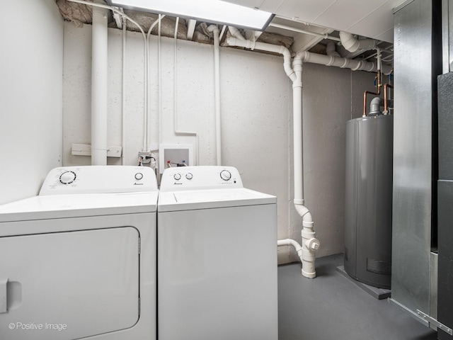 laundry room with gas water heater and washer and dryer