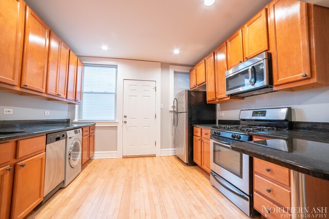 kitchen with stainless steel appliances, washer / clothes dryer, light wood-style floors, recessed lighting, and brown cabinetry