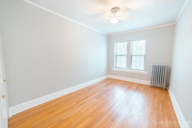 unfurnished room featuring radiator, light wood finished floors, baseboards, ornamental molding, and a ceiling fan