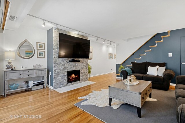 3700 N Lake Shore Dr Unit 312, Chicago, IL 60613 - living area featuring rail lighting, wood finished floors, and a fireplace