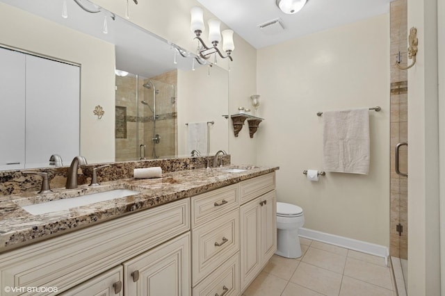 full bathroom with tile patterned flooring, a stall shower, baseboards, double vanity, and toilet