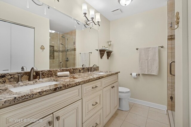 3700 N Lake Shore Dr Unit 312, Chicago, IL 60613 - bathroom with tile patterned flooring, double vanity, a stall shower, and a chandelier