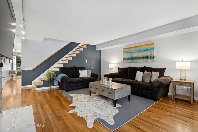 3700 N Lake Shore Dr Unit 312, Chicago, IL 60613 - living room featuring stairs, hardwood / wood-style floors, and rail lighting
