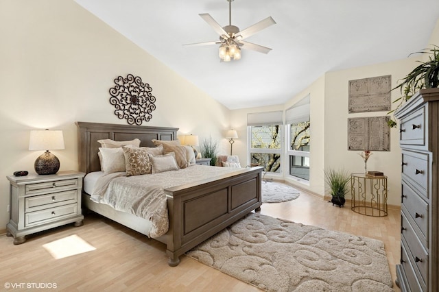 bedroom featuring light wood-style flooring, lofted ceiling, a ceiling fan, and baseboards