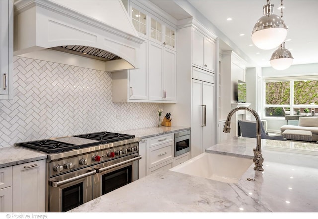1241 W Dickens Ave, Chicago, IL 60614 - kitchen with built in appliances, custom range hood, a sink, white cabinets, and glass insert cabinets