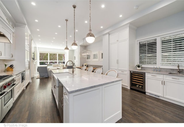 1241 W Dickens Ave, Chicago, IL 60614 - kitchen featuring beverage cooler, a sink, dark wood-style flooring, open floor plan, and white cabinetry