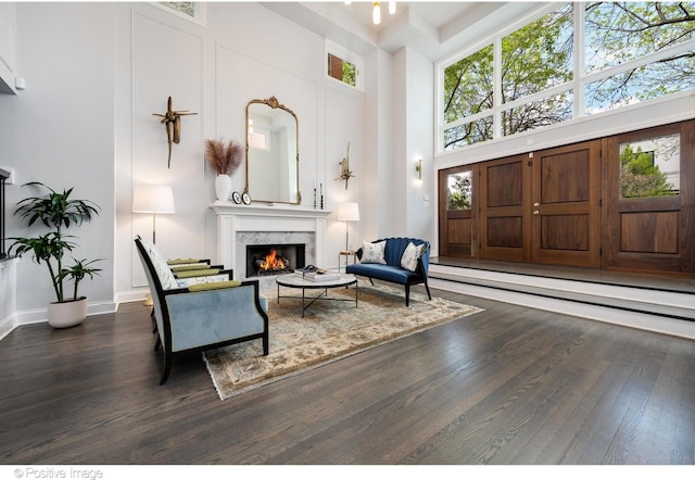 1241 W Dickens Ave, Chicago, IL 60614 - sitting room featuring a towering ceiling, wood finished floors, a fireplace, baseboard heating, and baseboards