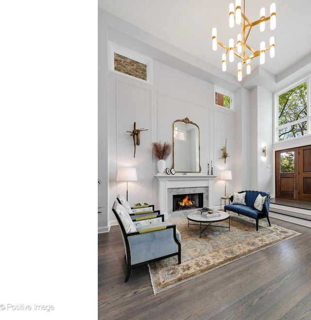 1241 W Dickens Ave, Chicago, IL 60614 - living area featuring wood finished floors, a towering ceiling, a fireplace, and a chandelier