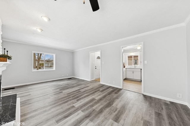 19 N Iowa Ave, Addison, IL 60101 - unfurnished living room with ceiling fan, a fireplace, wood finished floors, crown molding, and baseboards