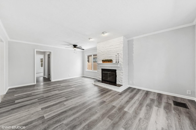 19 N Iowa Ave, Addison, IL 60101 - unfurnished living room featuring ornamental molding, ceiling fan, a stone fireplace, baseboards, and wood finished floors
