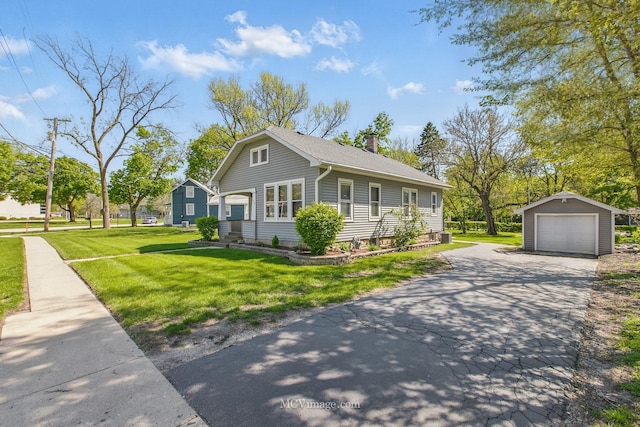 137 E Tyler St, Oswego, IL 60543 - view of front of home with a chimney, an outdoor structure, a detached garage, driveway, and a front lawn