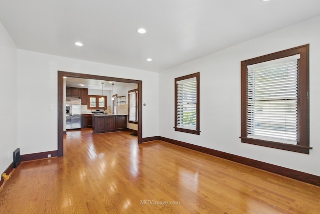 137 E Tyler St, Oswego, IL 60543 - unfurnished living room with baseboards, light wood-style flooring, and recessed lighting