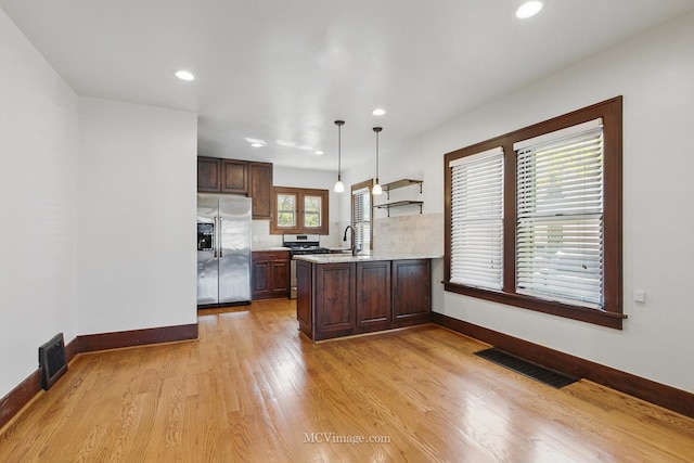 137 E Tyler St, Oswego, IL 60543 - kitchen with appliances with stainless steel finishes, light wood-style flooring, recessed lighting, dark brown cabinets, and a peninsula
