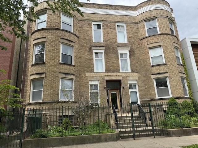 6116 S Ellis Ave Unit 1, Chicago, IL 60637 - view of front of property with a fenced front yard and brick siding