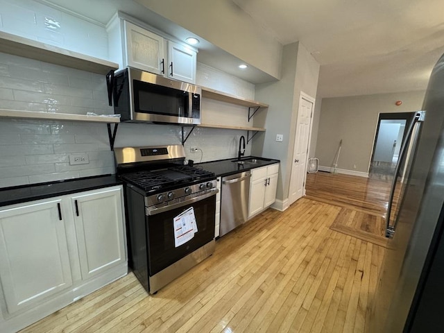 6116 S Ellis Ave Unit 1, Chicago, IL 60637 - kitchen with open shelves, appliances with stainless steel finishes, a sink, dark countertops, and light wood finished floors