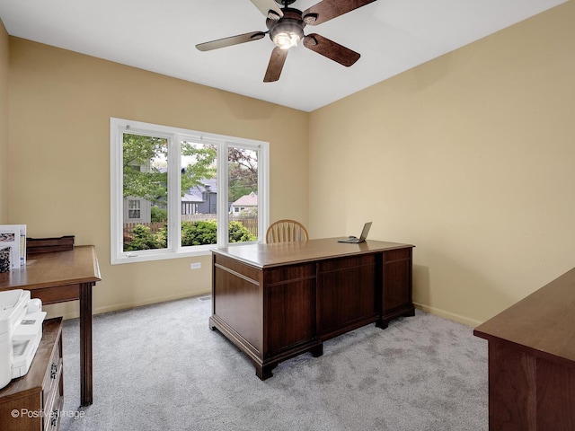 office with light colored carpet, ceiling fan, and baseboards