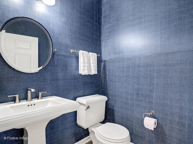 half bath with toilet and a sink