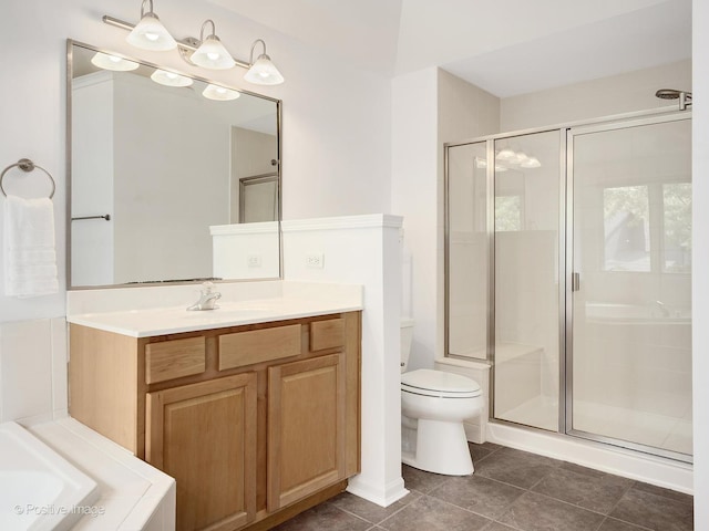 bathroom featuring toilet, a shower stall, tile patterned floors, and vanity