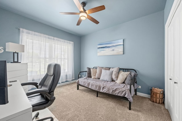 office featuring carpet floors, ceiling fan, and baseboards