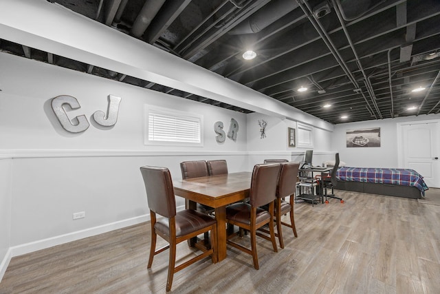 dining space with wood finished floors and baseboards