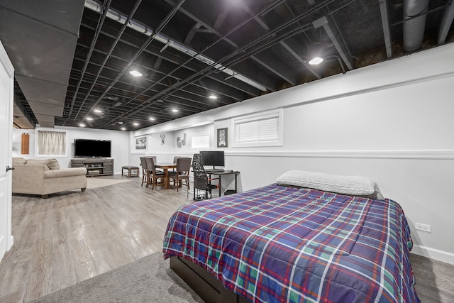 bedroom with wood finished floors and baseboards