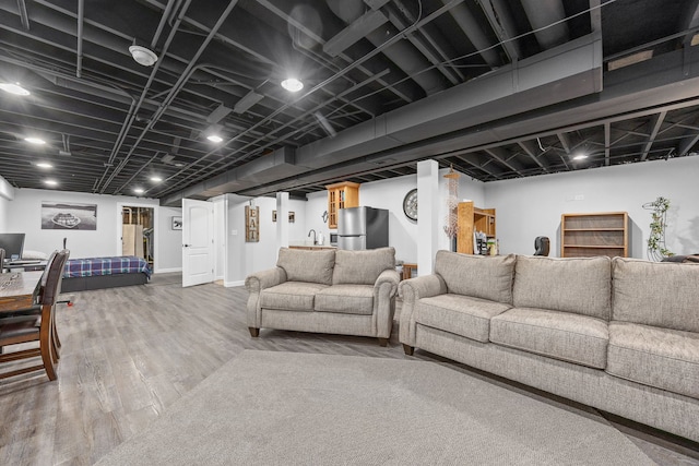 living area with wood finished floors and bar area