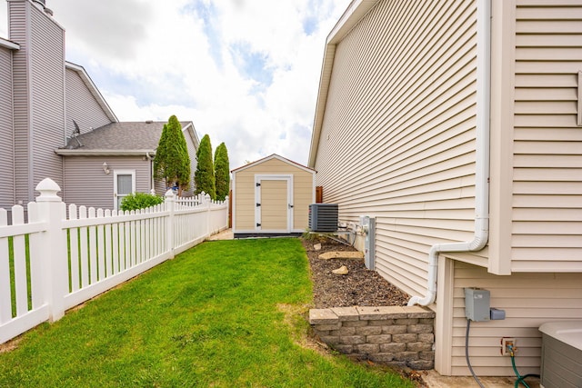 view of yard featuring a storage shed, an outbuilding, and central AC
