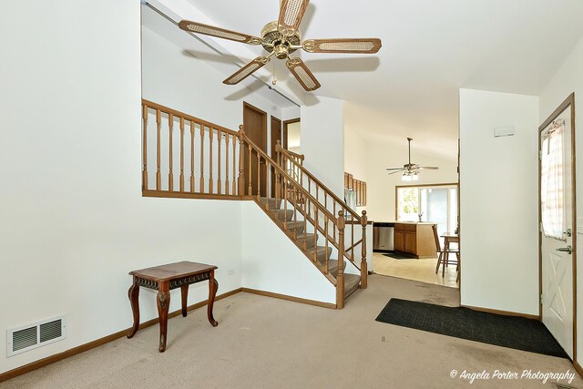 782 N Hainesville Rd, Round Lake, IL 60073 - carpeted entryway featuring ceiling fan, vaulted ceiling, baseboards, and stairway