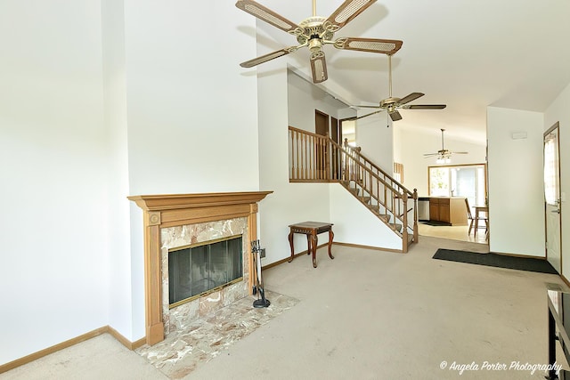 782 N Hainesville Rd, Round Lake, IL 60073 - carpeted living room with stairway, a ceiling fan, baseboards, a fireplace, and high vaulted ceiling