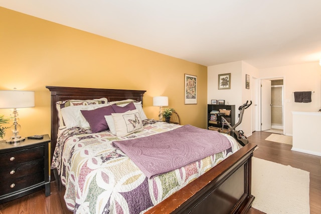 bedroom featuring dark wood-type flooring and baseboards