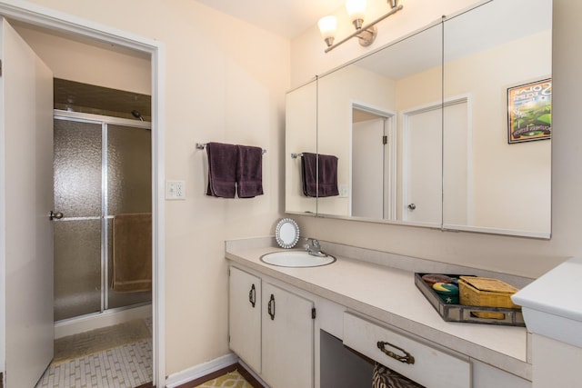 bathroom with a shower stall and vanity