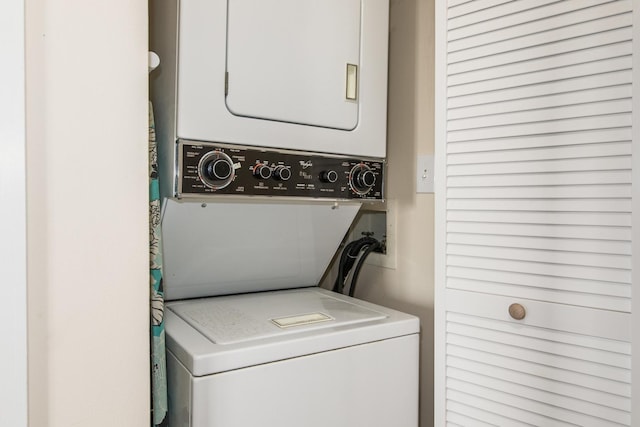 clothes washing area featuring stacked washer / dryer