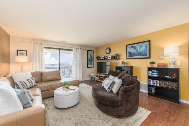 living room with wood finished floors and baseboards