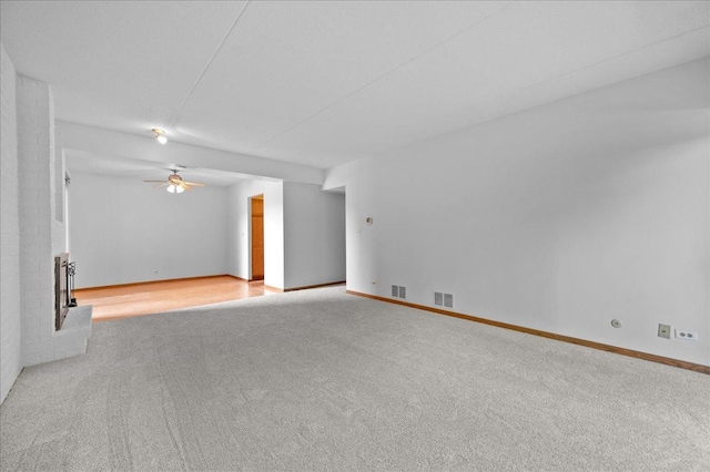 1502 Woodbridge Rd Unit 1D, Joliet, IL 60436 - carpeted spare room with a fireplace, a ceiling fan, and baseboards