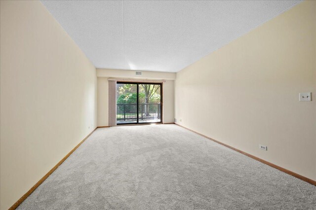 1502 Woodbridge Rd Unit 1D, Joliet, IL 60436 - empty room featuring carpet floors, baseboards, and a textured ceiling