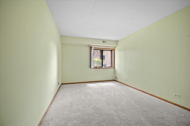 1502 Woodbridge Rd Unit 1D, Joliet, IL 60436 - empty room featuring carpet flooring, baseboards, and a textured ceiling