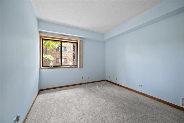 1502 Woodbridge Rd Unit 1D, Joliet, IL 60436 - spare room with carpet flooring, baseboards, and a textured ceiling