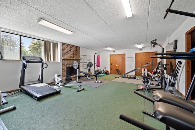 1502 Woodbridge Rd Unit 1D, Joliet, IL 60436 - workout area featuring a textured ceiling and a brick fireplace