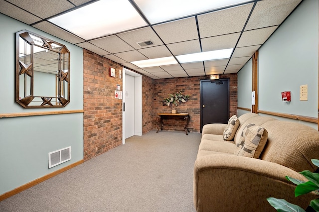 1502 Woodbridge Rd Unit 1D, Joliet, IL 60436 - carpeted living area with brick wall, baseboards, and a paneled ceiling