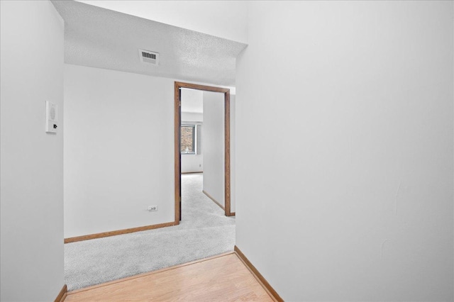 1502 Woodbridge Rd Unit 1D, Joliet, IL 60436 - hall with baseboards, wood finished floors, carpet floors, and a textured ceiling