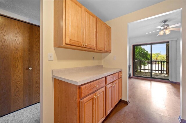1502 Woodbridge Rd Unit 1D, Joliet, IL 60436 - kitchen featuring light countertops, a ceiling fan, and baseboards